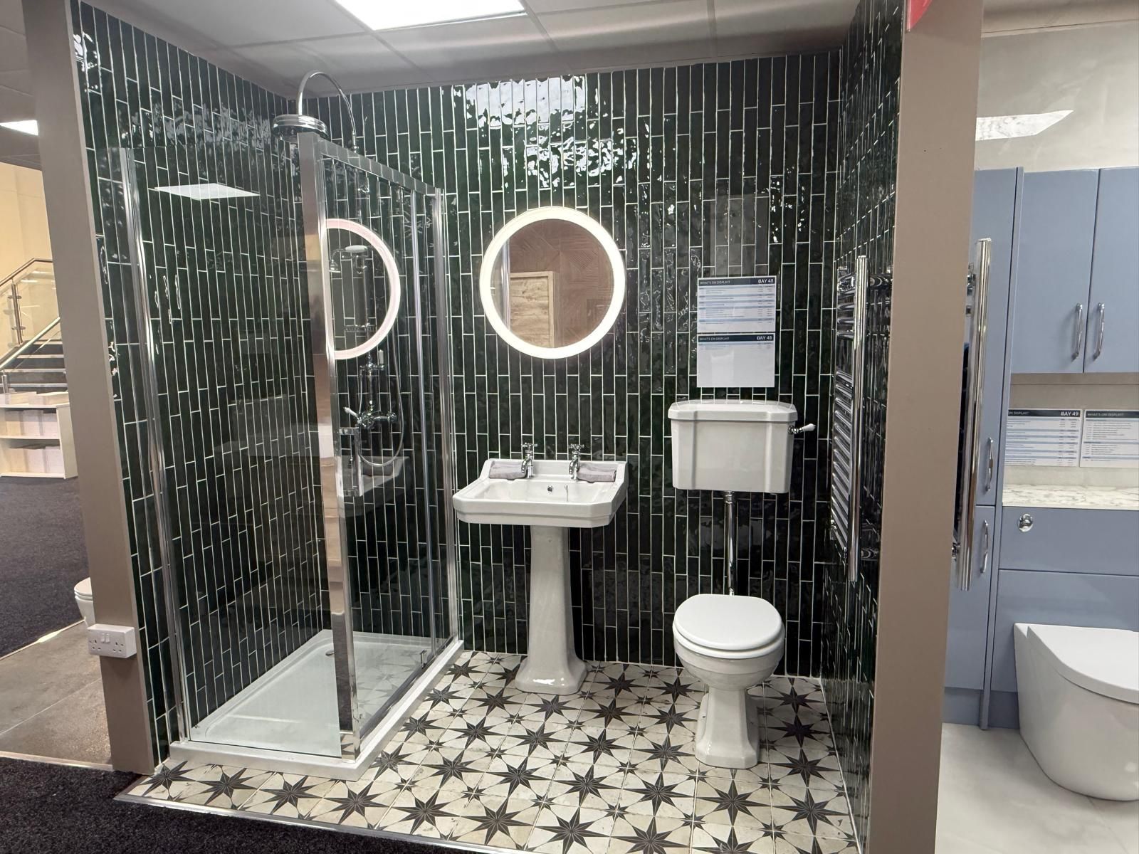 Showroom bathroom showroom with boho chic floor tiles, vertical metro tiles, traditional bathroom furniture and an LED mirror