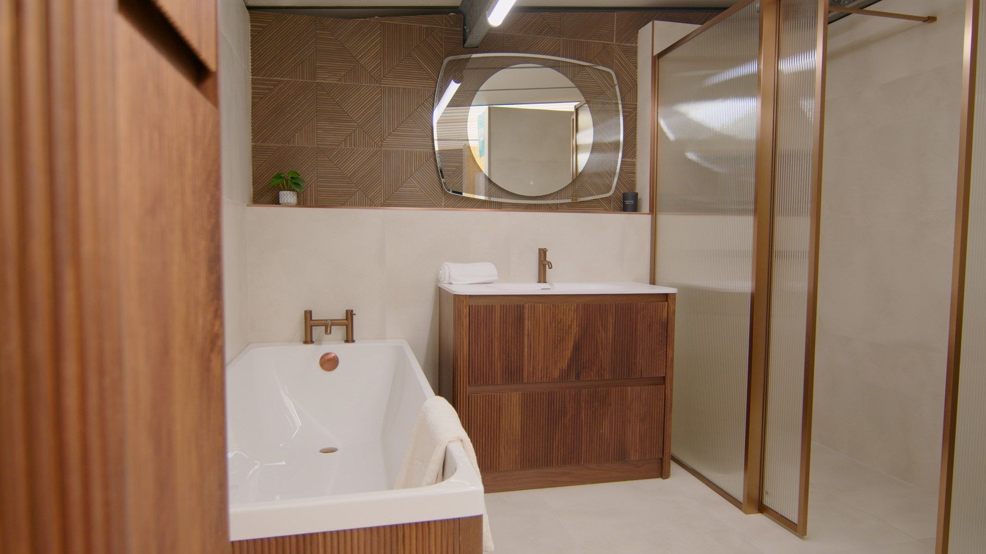 Bathroom showroom featuring modern wood furniture and warm lighting